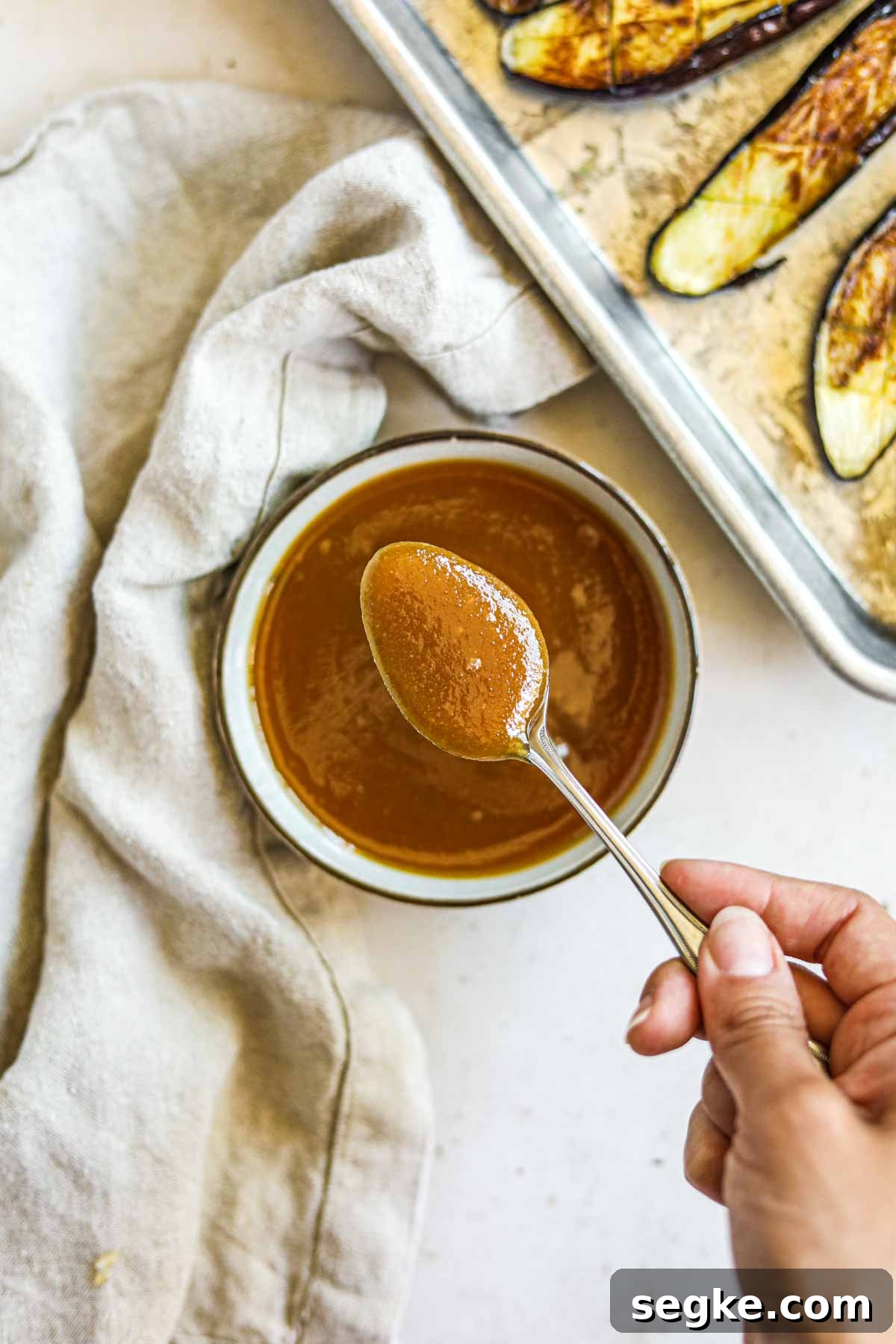 Creamy miso sauce (glaze and marinade) in a bowl with a spoon.