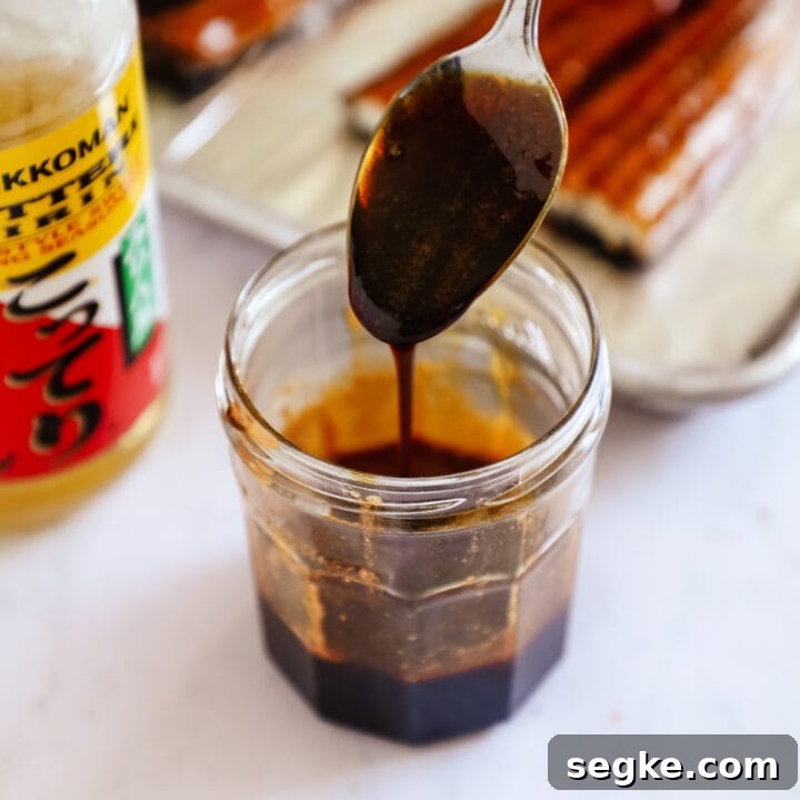 Unagi eel sauce in a jar with a spoon.