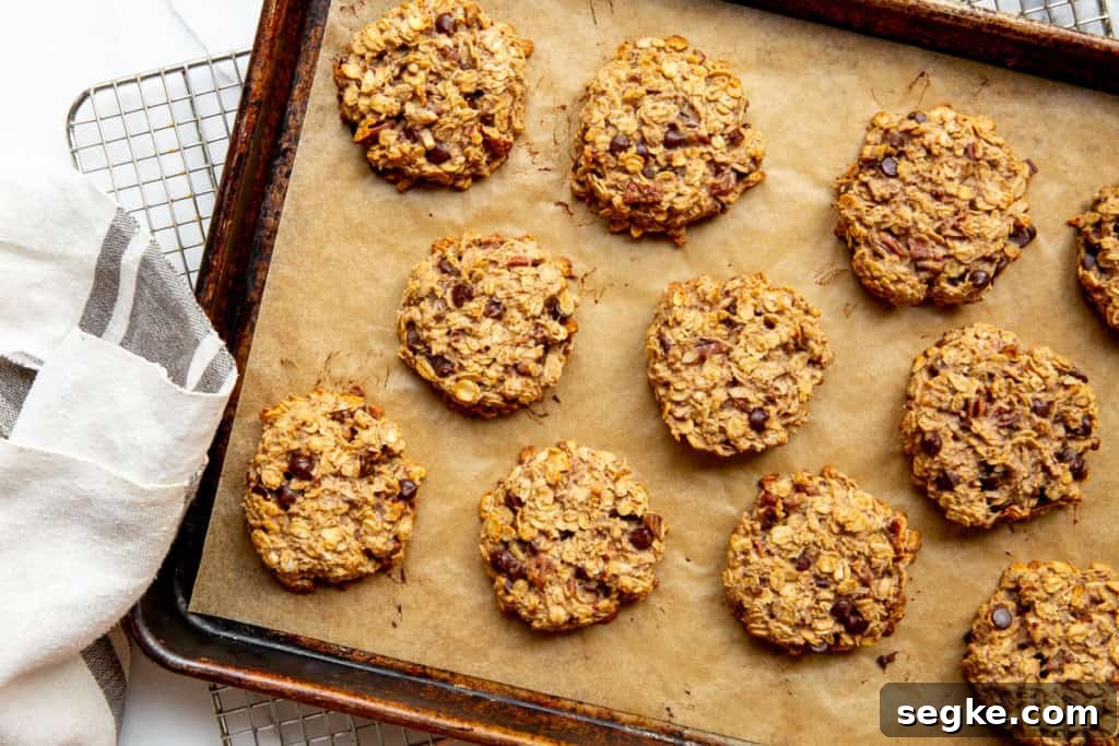 Banana Oat Breakfast Cookies - Gluten-Free Vegan 6 Banana oatcakes on a baking sheet.