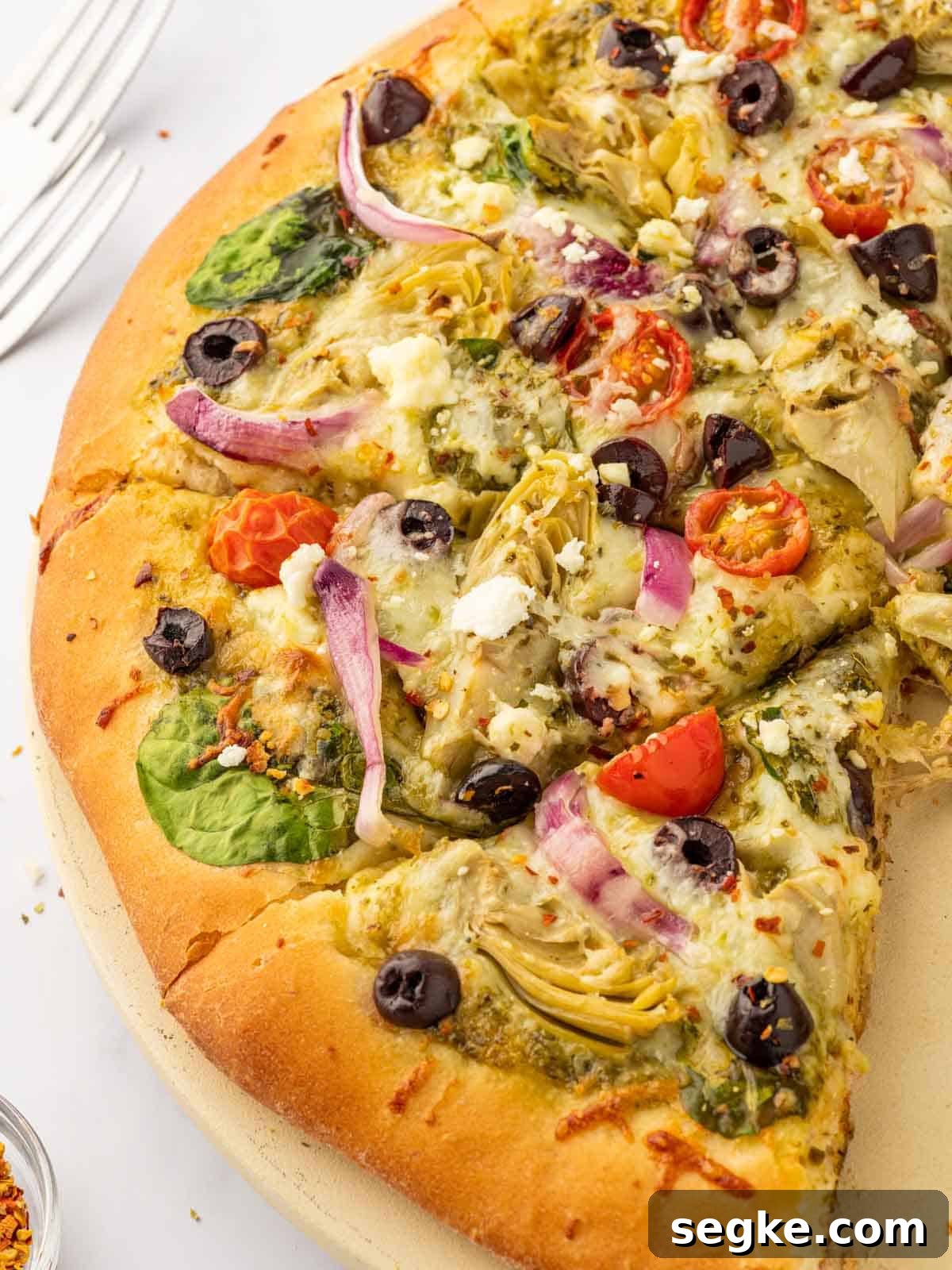 Homemade Crispy Mediterranean Pizza with Feta and Olives 6 Close up of pizza with feta, artichokes and olives.
