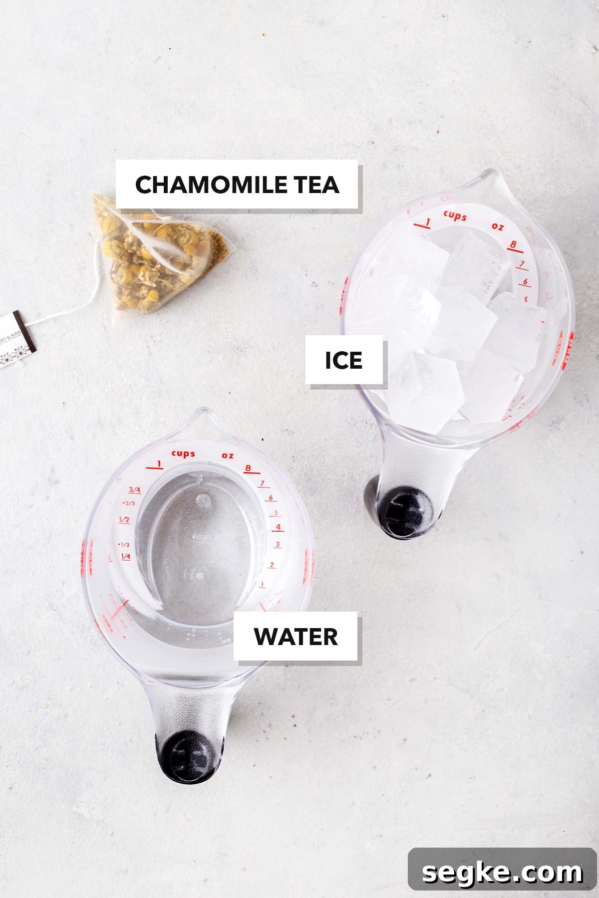 Refreshing Chamomile Iced Tea with Honey and Lemon 3 Chamomile Iced Tea ingredients measured in cups and labeled on a table.