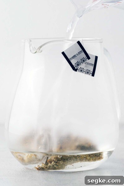 Refreshing Chamomile Iced Tea with Honey and Lemon 4 Steeping tea bags in a teapot.