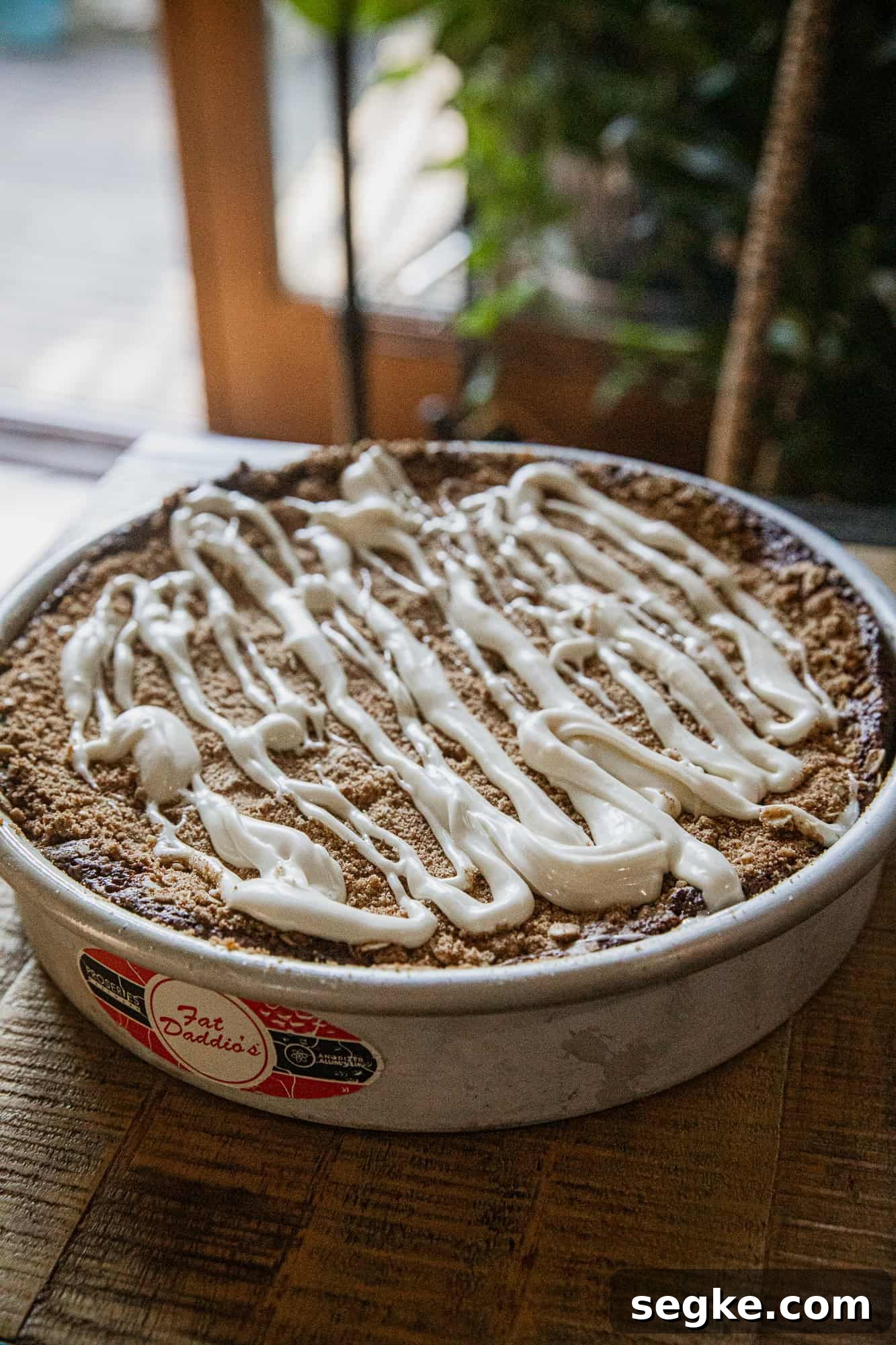 Delicious banana crumb cake topped with creamy drizzle, perfect for breakfast or dessert.