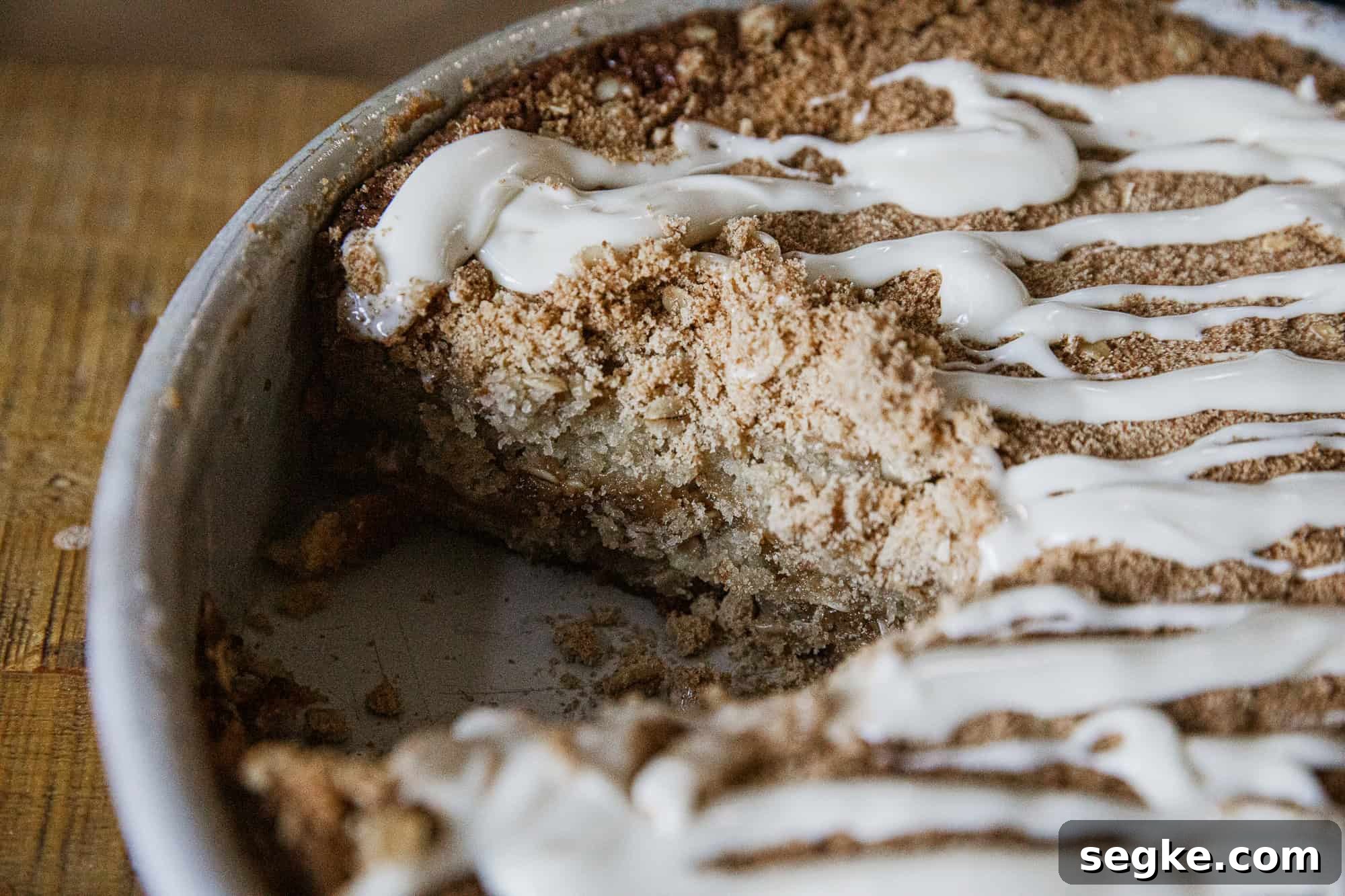Delicious banana crumb cake with a crunchy topping and creamy glaze, perfect for breakfast or dessert.