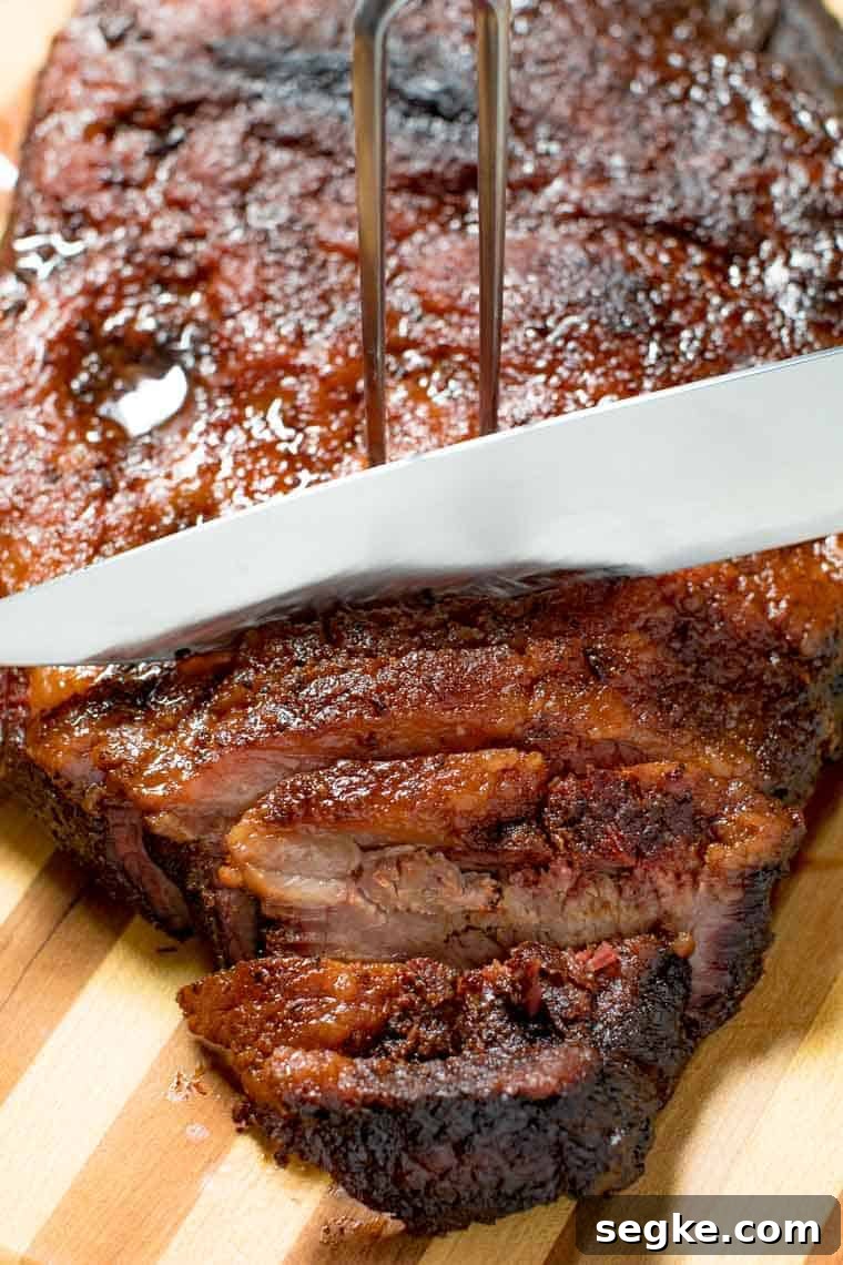 Smoked Brisket being cut with knife
