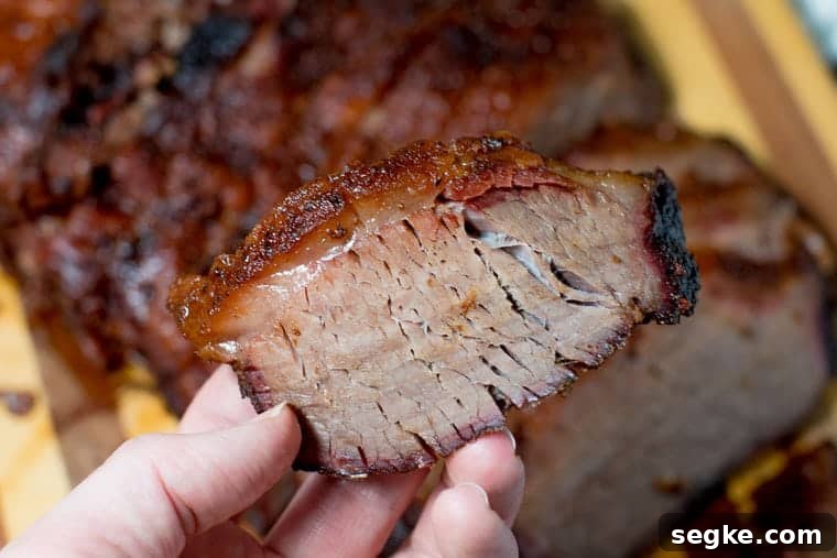 How to smoked a beef brisket in persons hand