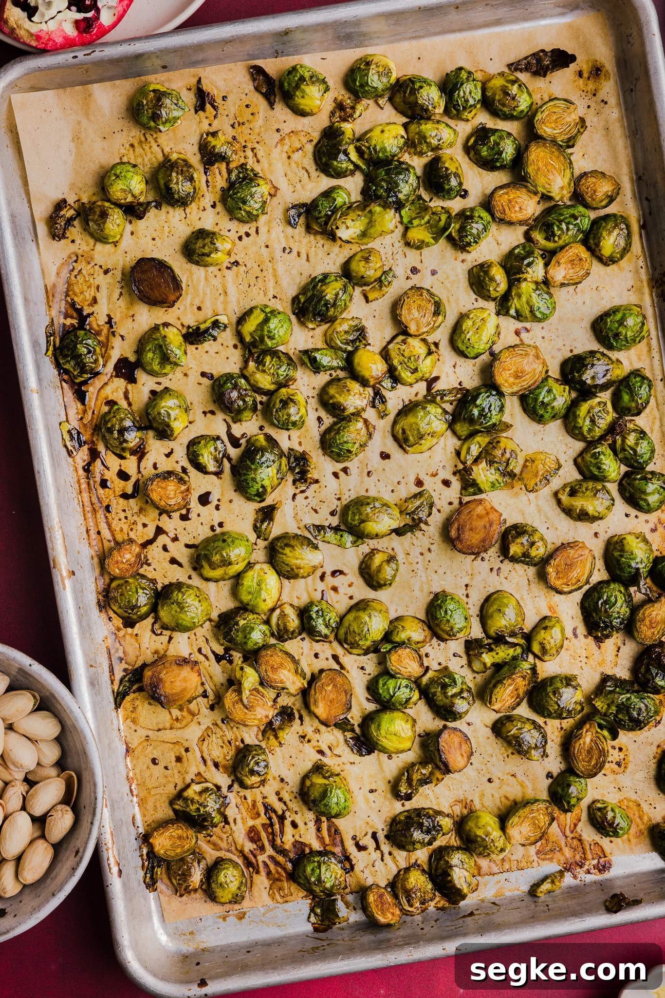 Roasted maple balsamic brussels sprouts on a sheet pan.
