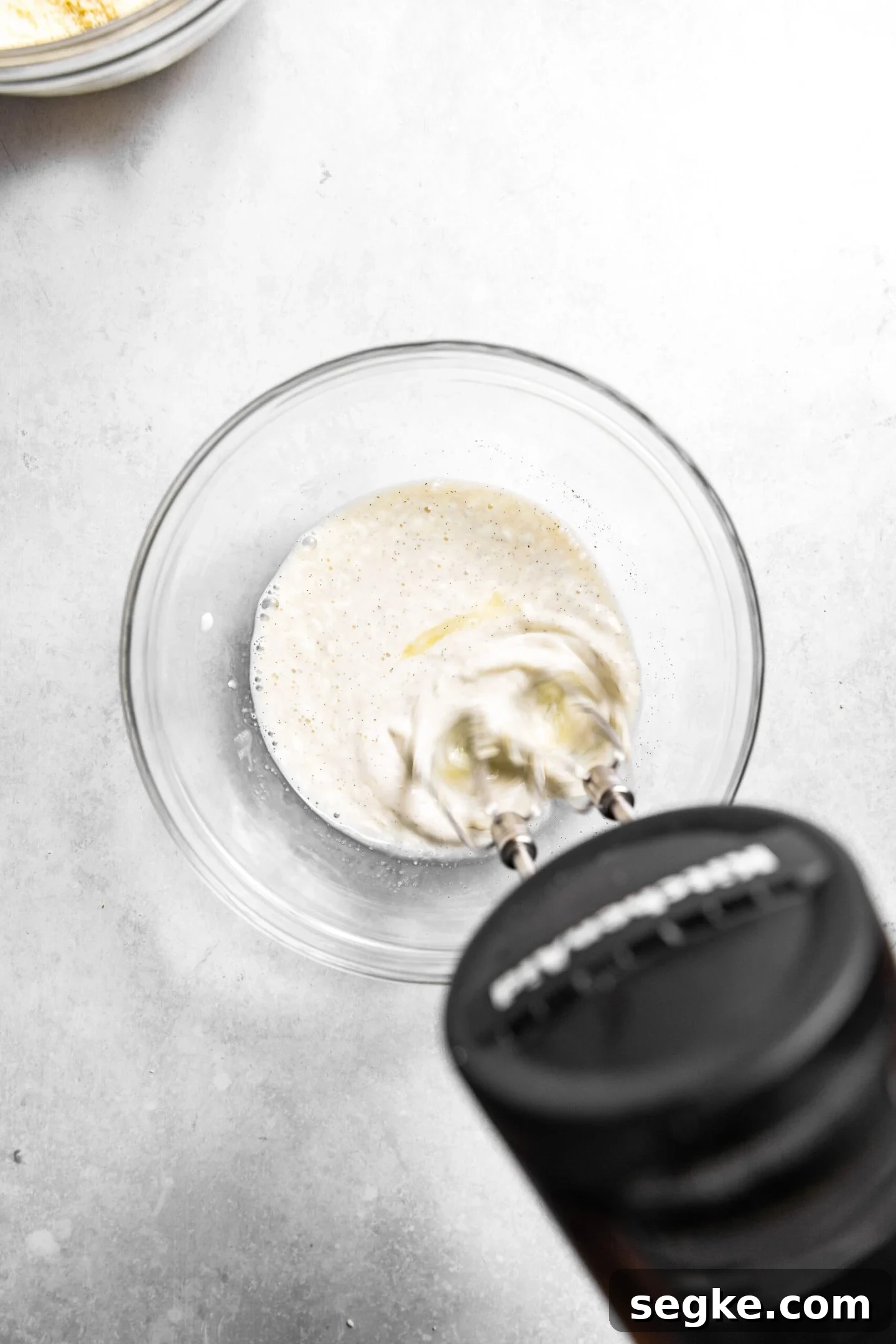 Oreo Cupcakes with Whipped Oreo Cream Frosting 5 Wet ingredients being whisked together in a small bowl.