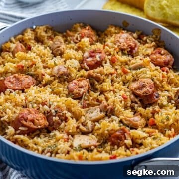 Cooked Chicken and Sausage Jambalaya in pan with toasted french bread on the side
