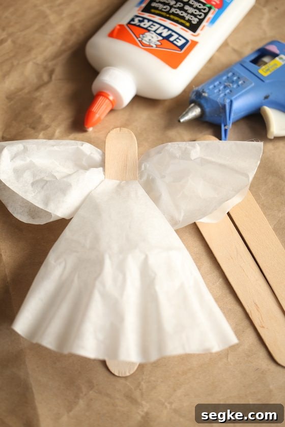 Gluing coffee filters to popsicle stick