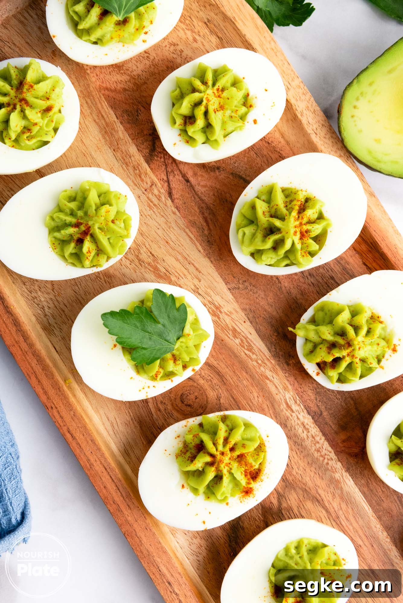 Creamy Avocado Deviled Eggs Recipe 7 Overhead shot of avocado deviled eggs placed on a wooden tray