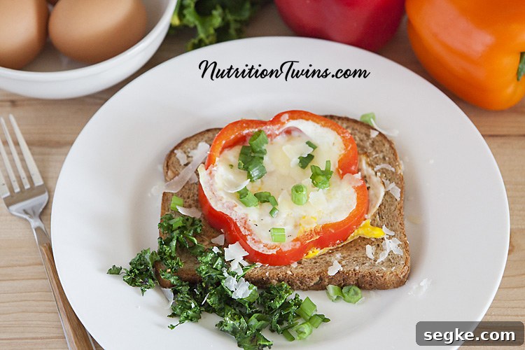 Baked Parmesan Eggs in Bell Pepper Rings 3 Bell pepper rings with cooked eggs and kale