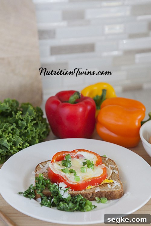 Baked Parmesan Eggs in Bell Pepper Rings 4 Prepared parmesan eggs in bell pepper ring on whole grain toast with sautéed kale