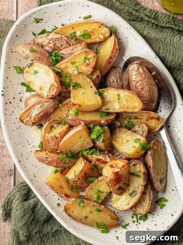 A spoon scooping potato salad on a plate.