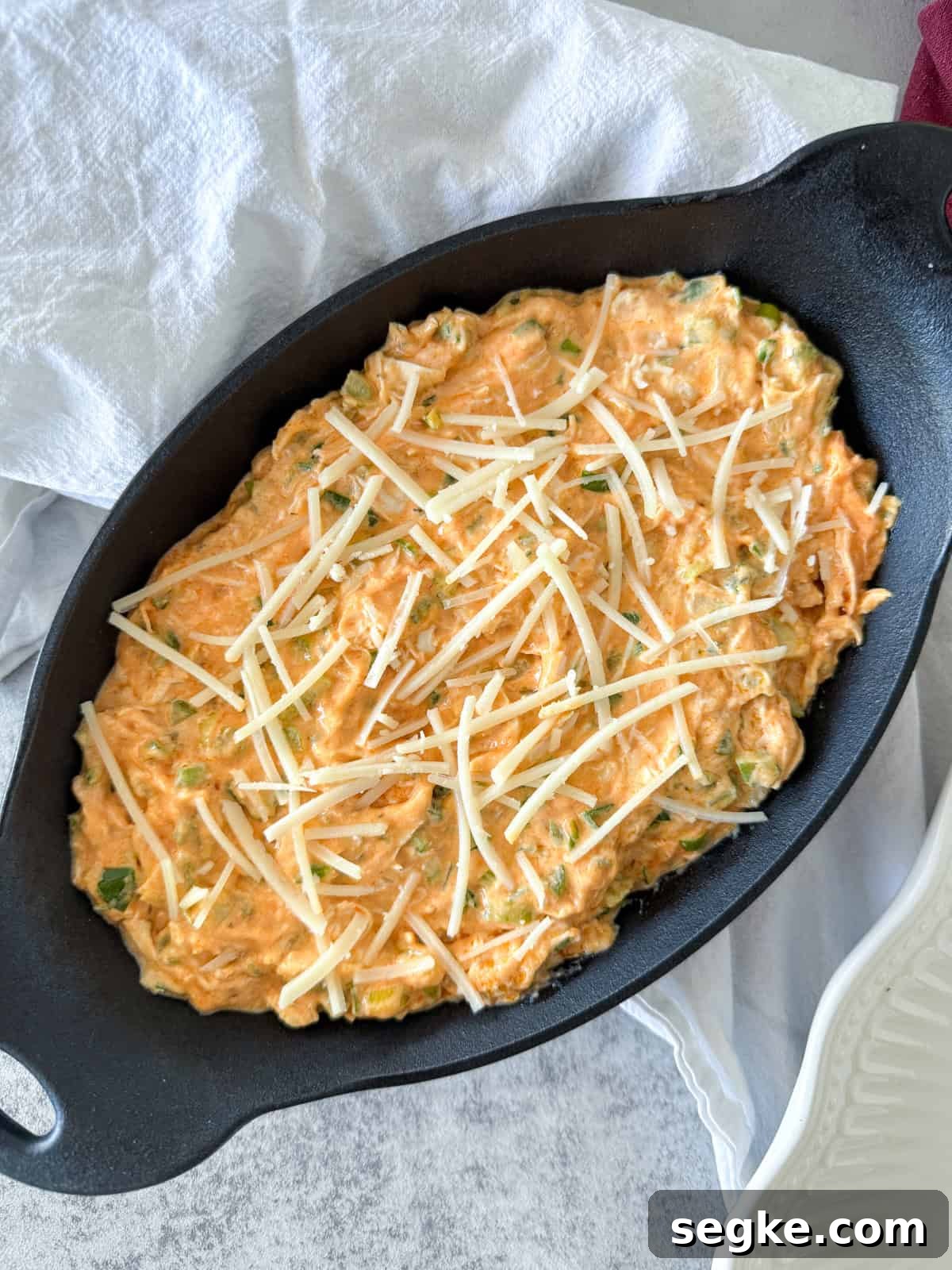 Dairy-Free Buffalo Chicken Dip Recipe 4 Buffalo chicken dip in a cast iron skillet before baking.