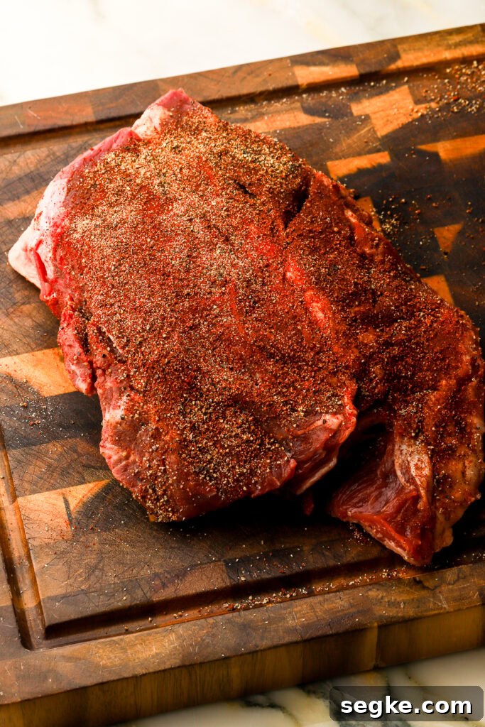 Everyday Braised Beef Recipe for Weeknight Dinners 3 beef chuck roast on a cutting board, patted dry and well seasoned
