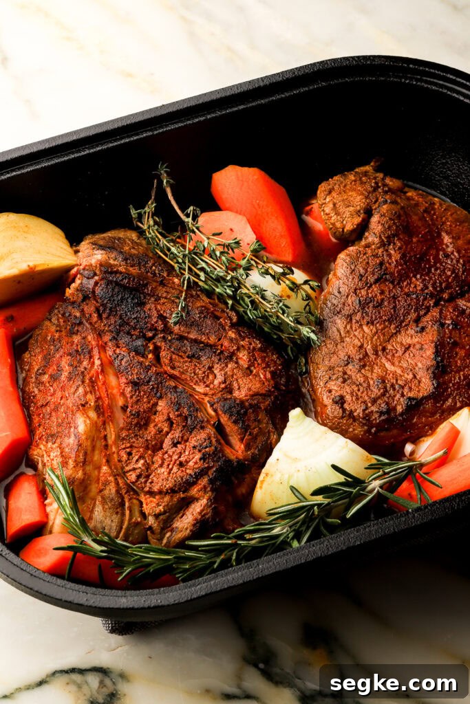Everyday Braised Beef Recipe for Weeknight Dinners 6 beef ready to go in the oven with vegetables and broth