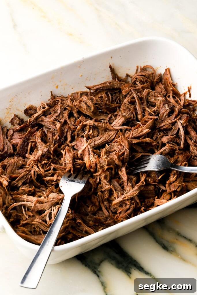 Everyday Braised Beef Recipe for Weeknight Dinners 9 Beef shredded with forks in the serving dish