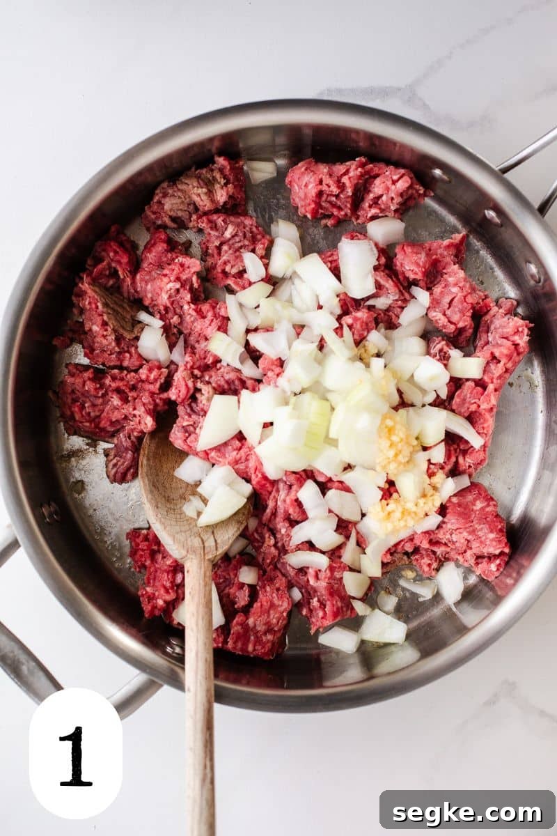 Cheesy Ground Beef Pasta Bake 4 Ground beef and onion in a skillet.