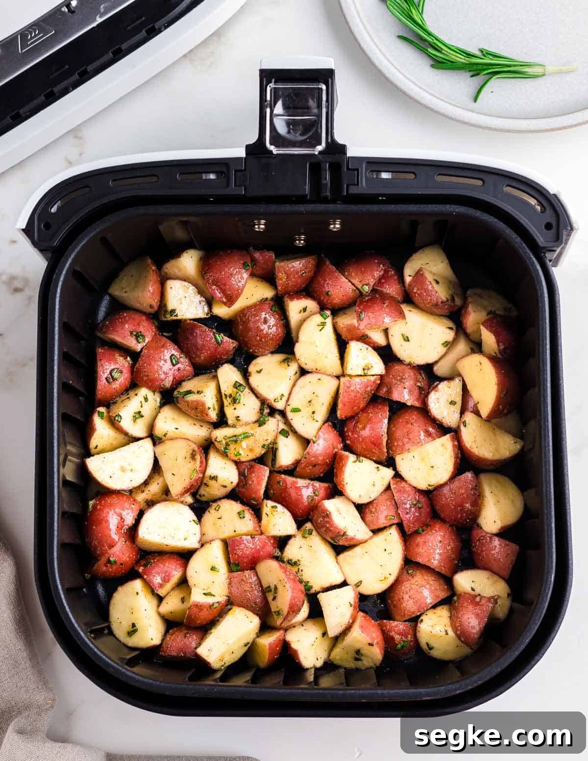 Perfectly Crispy Air Fryer Red Potatoes 4 Red potatoes in an air fryer.