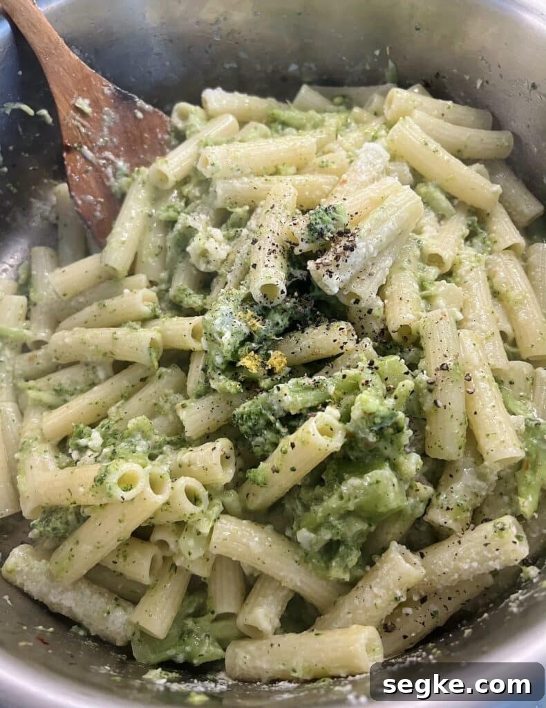 Lemony Broccoli Pasta with Pecorino 5 Finished Italian broccoli pasta in pan with wooden spoon.