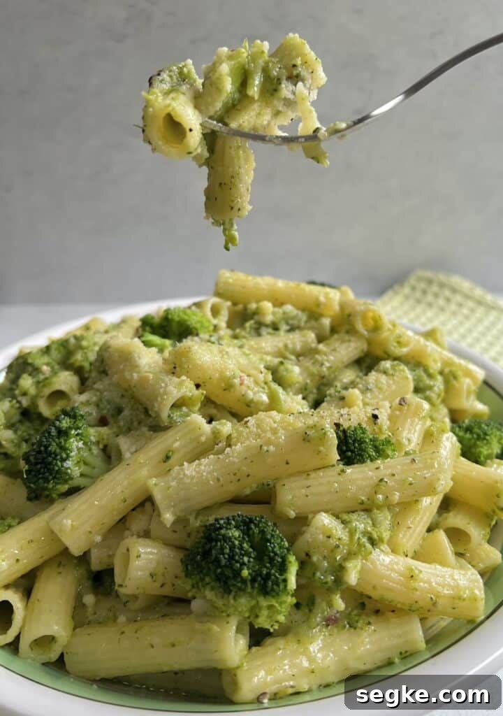Lemony Broccoli Pasta with Pecorino 6 Forkful of pasta with broccoli over bowl.