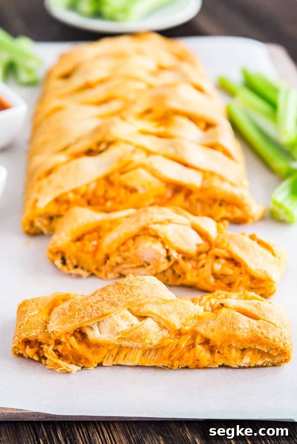 Cheesy Buffalo Chicken Puff Pastry Braid 2 Two slices of the Buffalo Chicken Braid with the rest of the braid behind it.