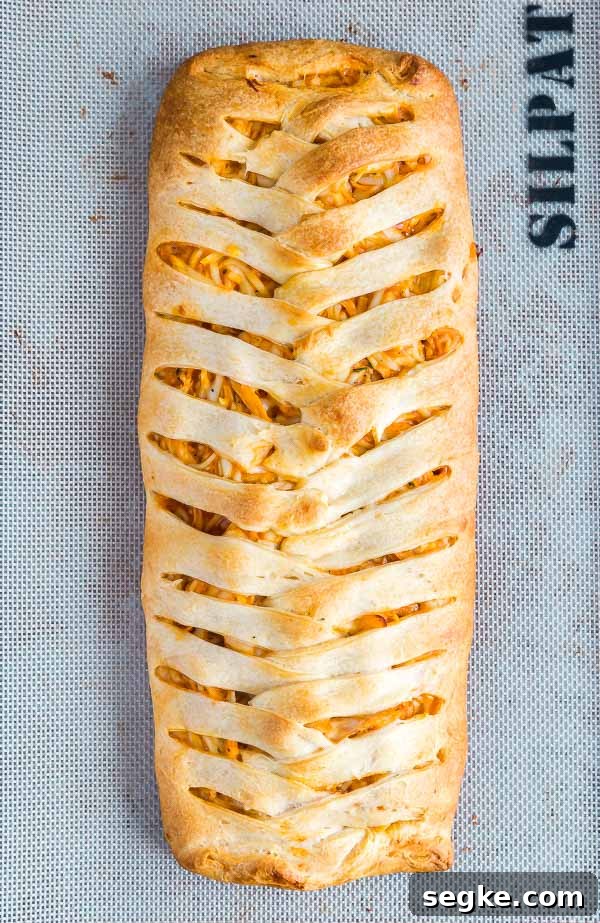 Cheesy Buffalo Chicken Puff Pastry Braid 3 A Buffalo Chicken Braid on a pan.
