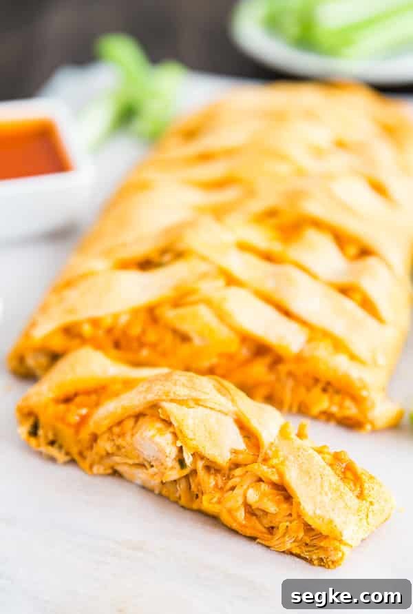 Cheesy Buffalo Chicken Puff Pastry Braid 5 A Buffalo Chicken Braid with a slice of it in the front.