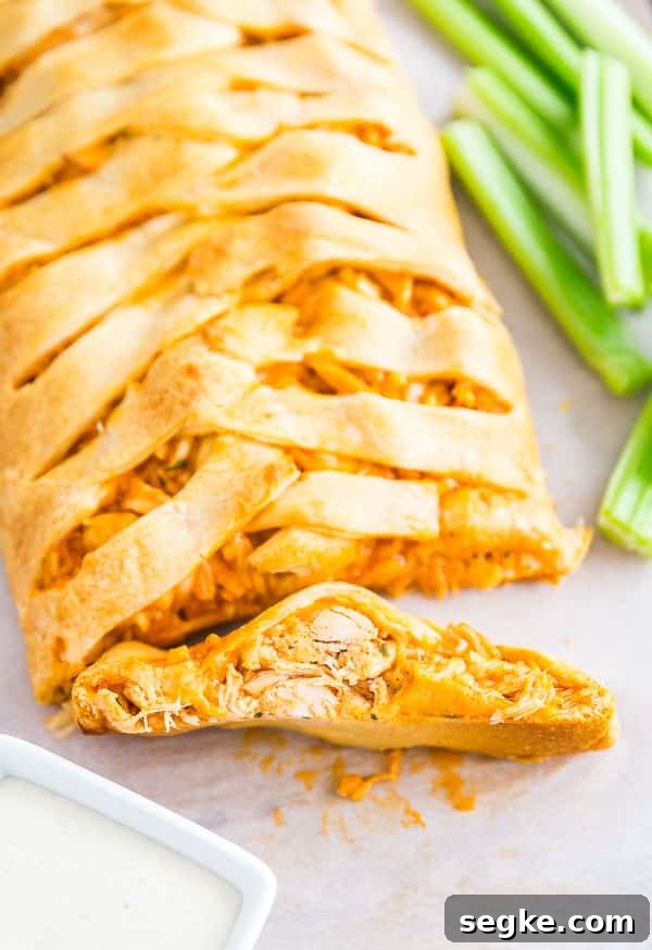 Cheesy Buffalo Chicken Puff Pastry Braid 6 A slice of Buffalo Chicken Braid facing the camera so you can see the filling.