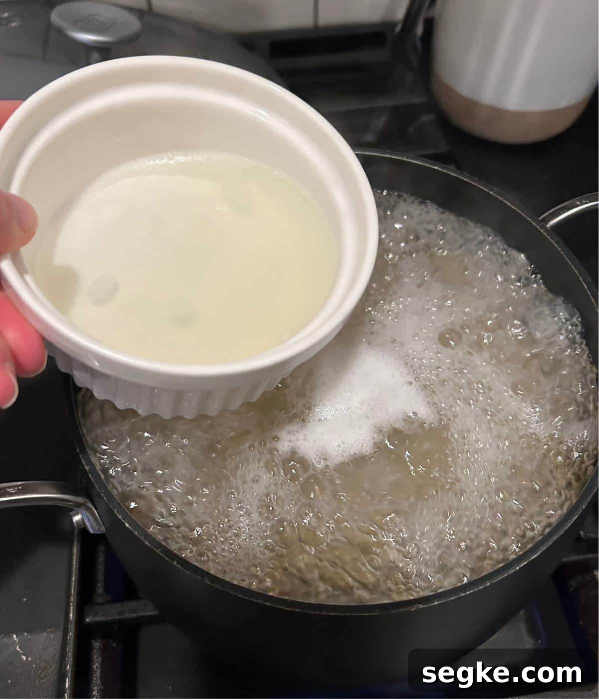 Pasta water boiling and reserving a bowl full. 