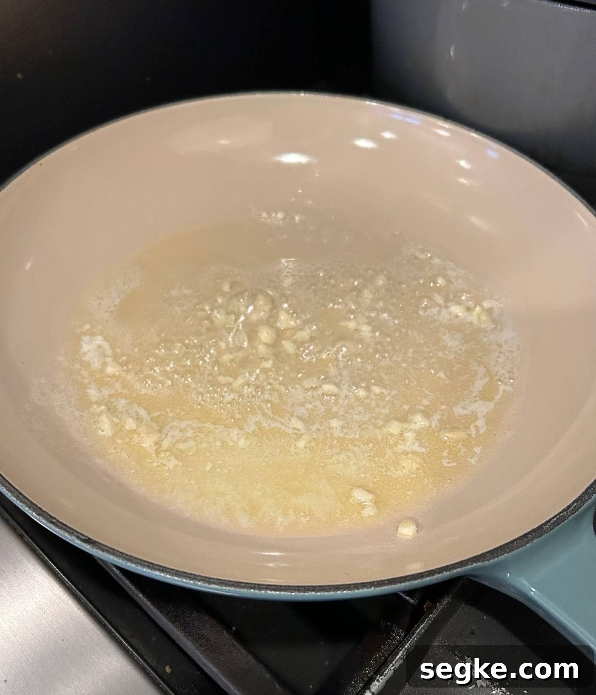 Garlic butter for creamy sauce cooking in skillet.