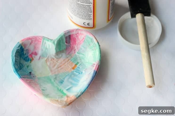 Add a bit of mod podge and tissue paper and completely transform this small bowl into a homemade jewelry dish! This technique also works on plates, jars, vases, and tile!