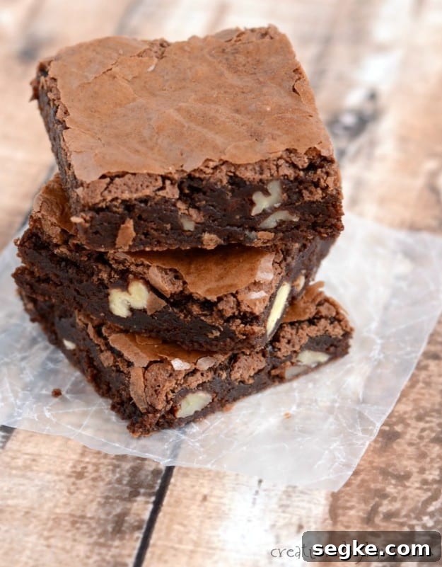stack of brownies on waxed paper