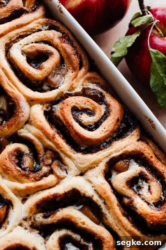 Apple Pie Cinnamon Rolls with Apple Cider Caramel Bottoms 11 Baked cinnamon rolls in the pan.