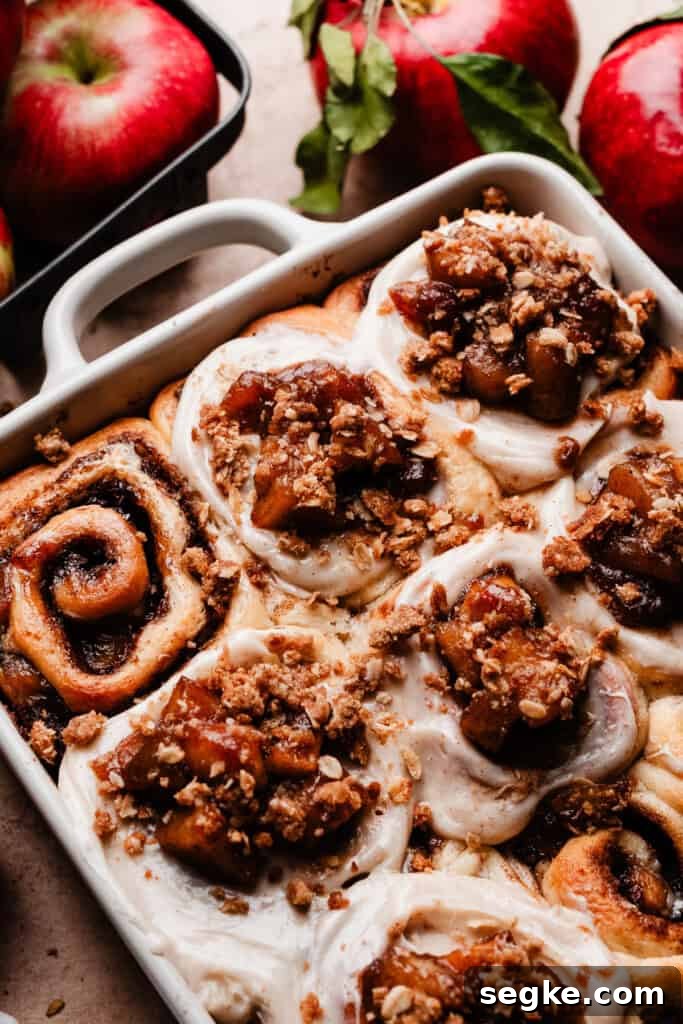 Apple Pie Cinnamon Rolls with Apple Cider Caramel Bottoms 13 A pan of the frosted & topped apple pie cinnamon rolls.