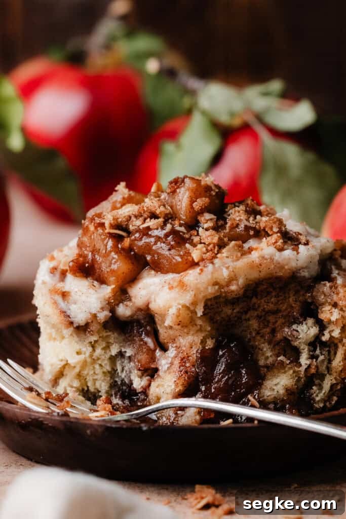Apple Pie Cinnamon Rolls with Apple Cider Caramel Bottoms 3 An apple pie cinnamon roll on a plate.