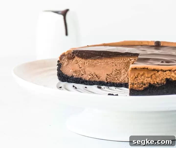 Decadent Triple Chocolate Cheesecake Recipe 2 Triple chocolate cheesecake on a cake stand with two slices taken out
