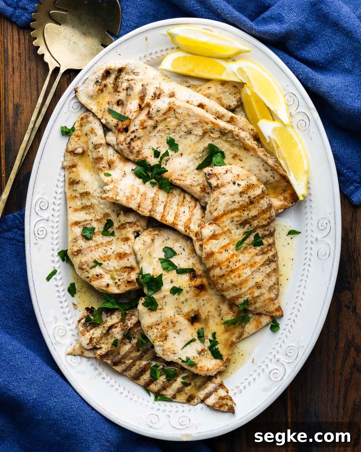 How to Make Juicy Marinated Grilled Chicken 2 Platter of marinated grilled chicken with lemon wedges.