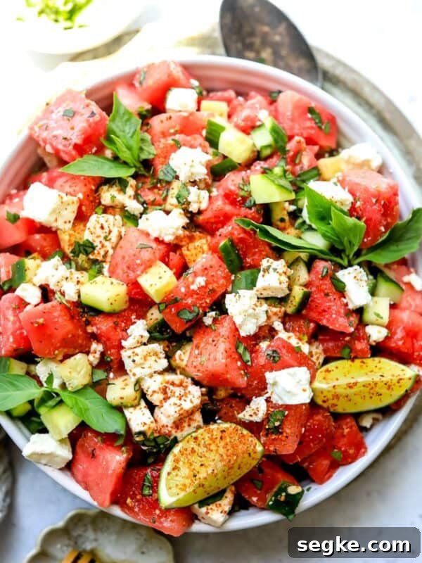 White bowl with watermelon, basil, and feta salad.