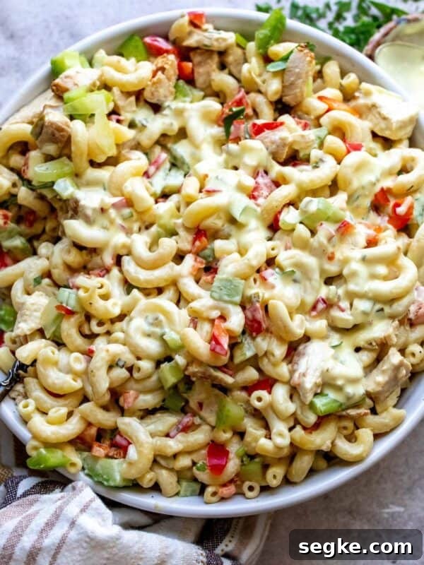 White ceramic bowl filled with chicken macaroni pasta salad.