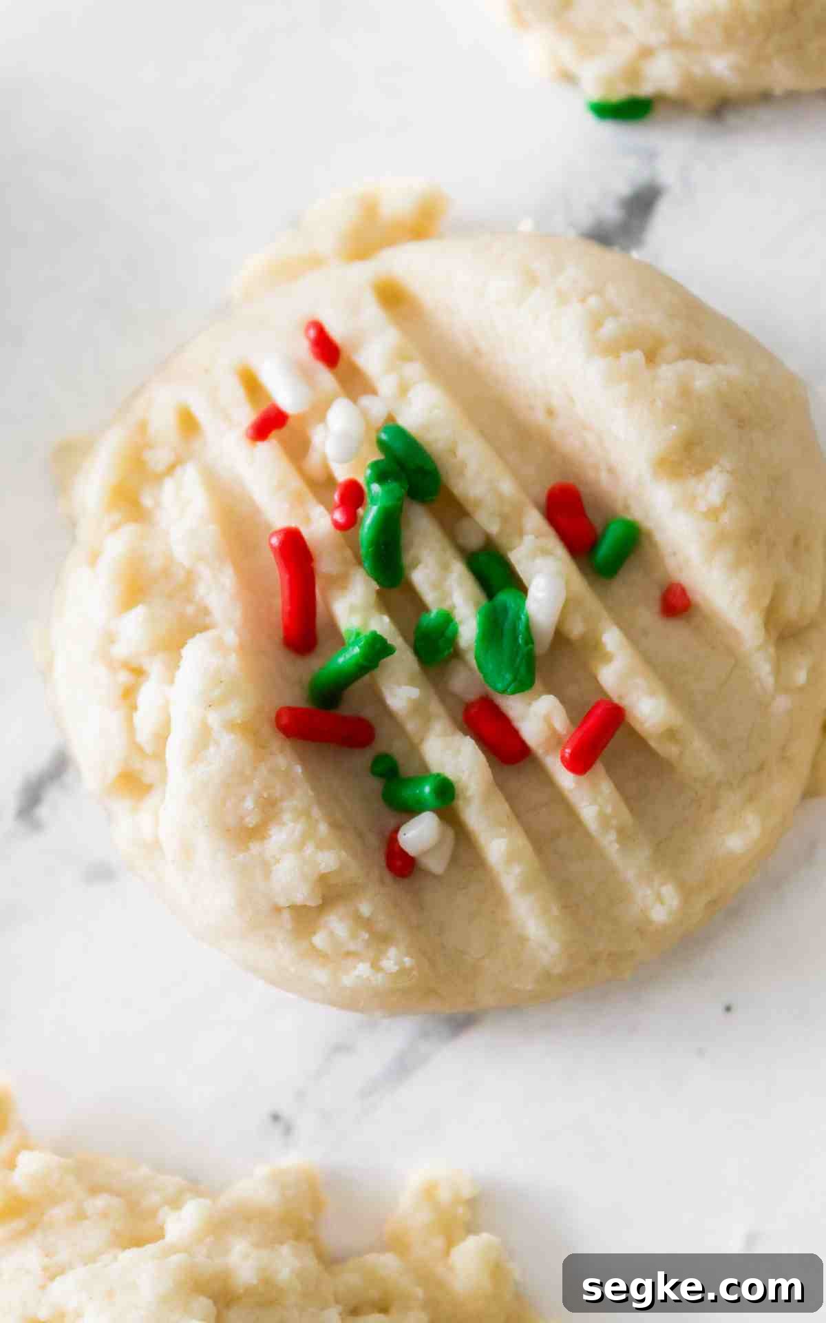 Light, Fluffy Whipped Shortbread Cookies Recipe 7 A whipped shortbread cookie on marble background.