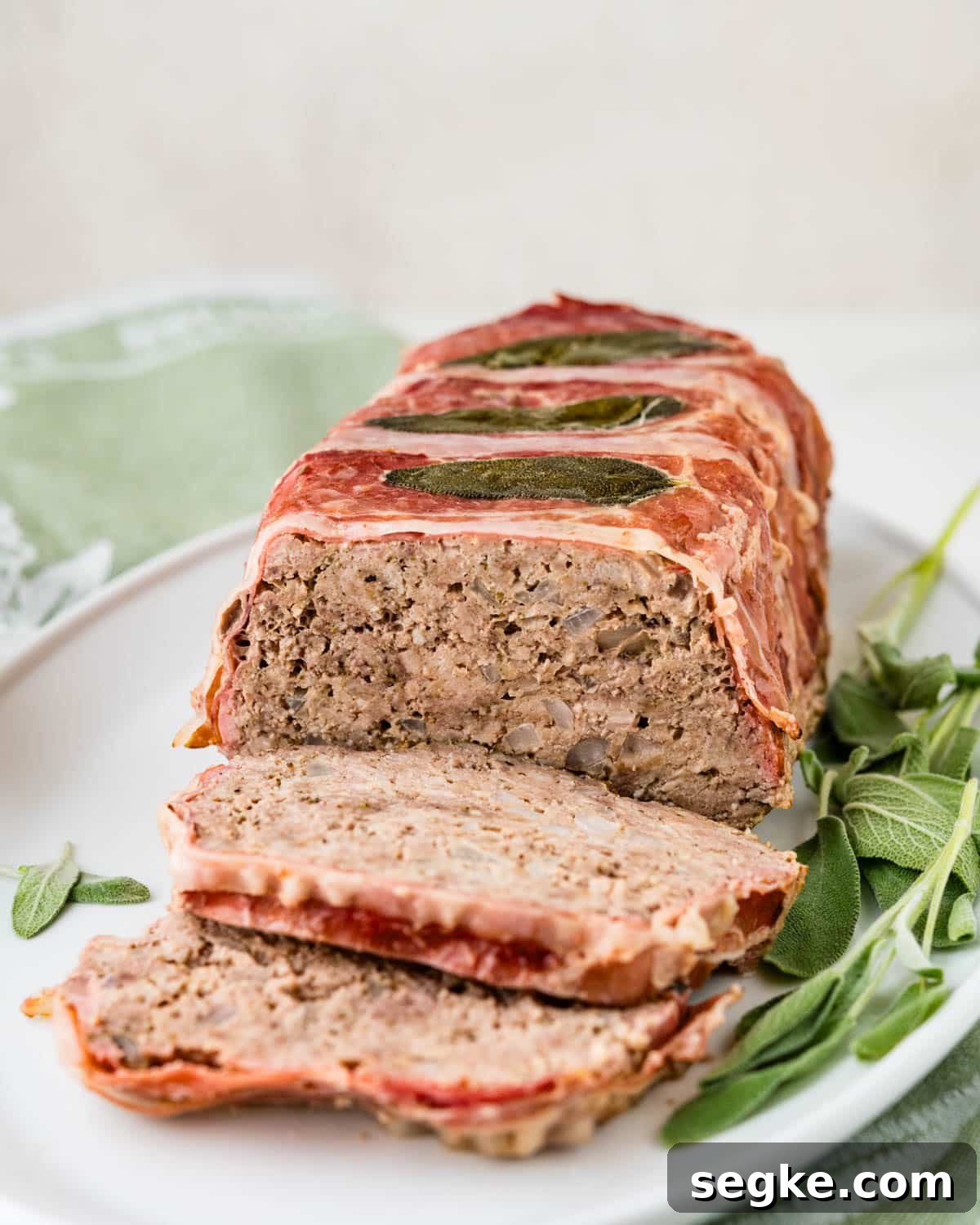 Oven Baked Meatloaf with Creamy Mushroom Gravy 8 Beef and pork meatloaf on a platter.