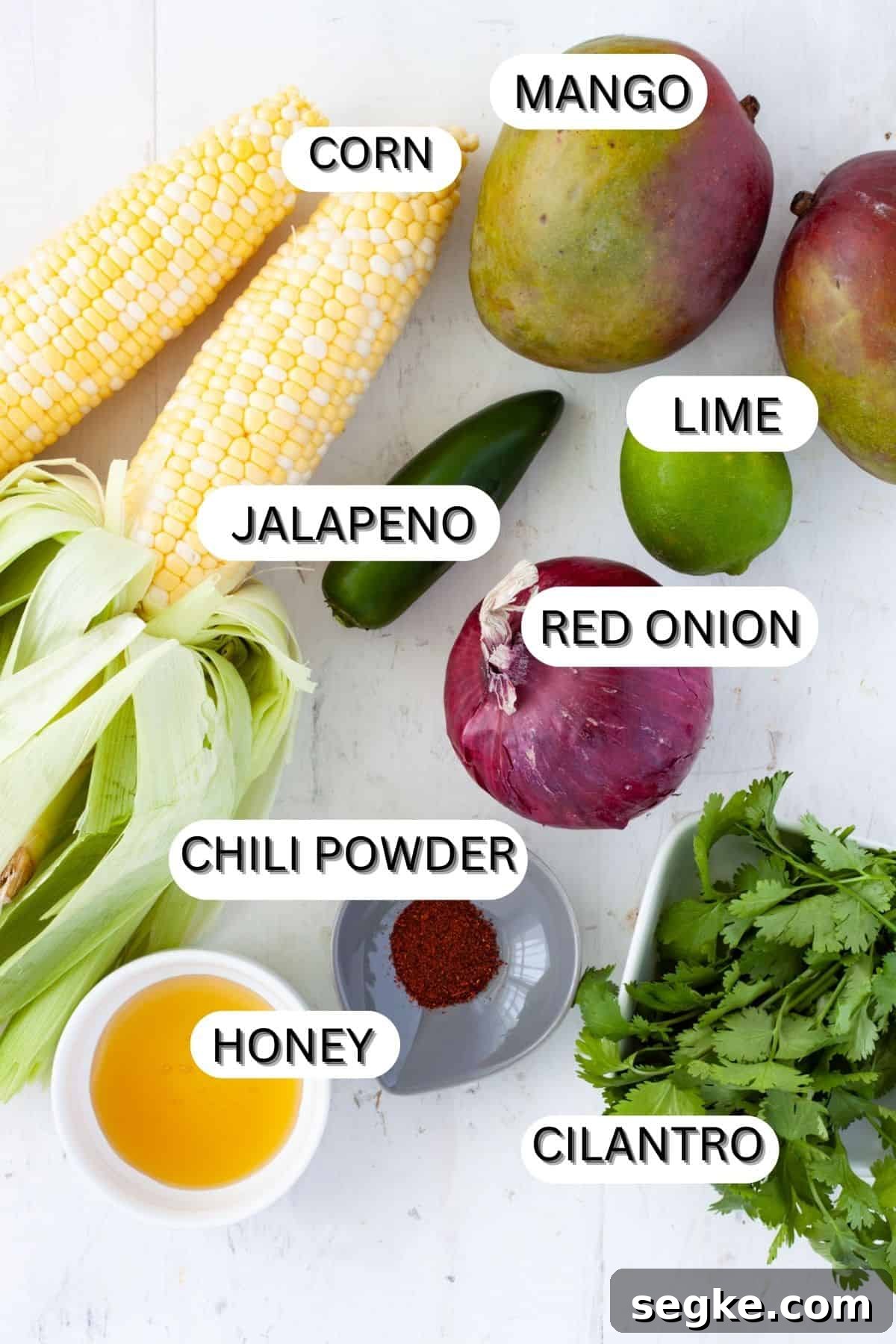 Ingredients for mango and corn salsa on a table.