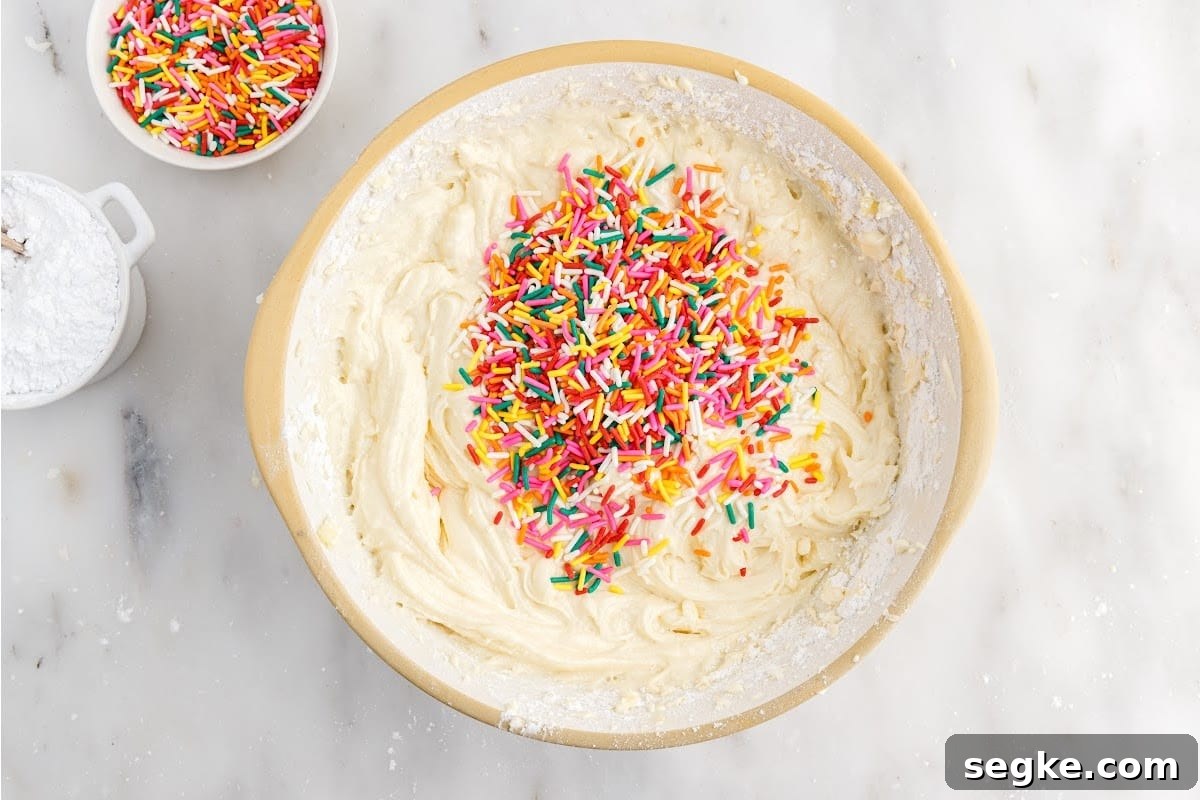 Funfetti Cake Recipe with Rainbow Sprinkles 8 Sprinkles added to cake batter.