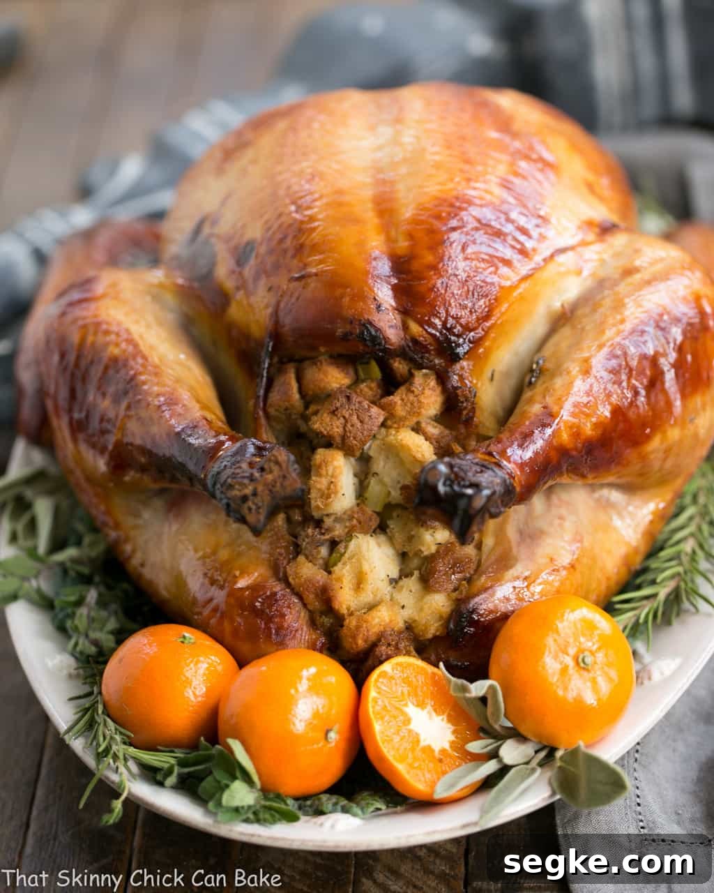 Honey Brined Turkey Recipe view of stuffing end with herbs and oranges.