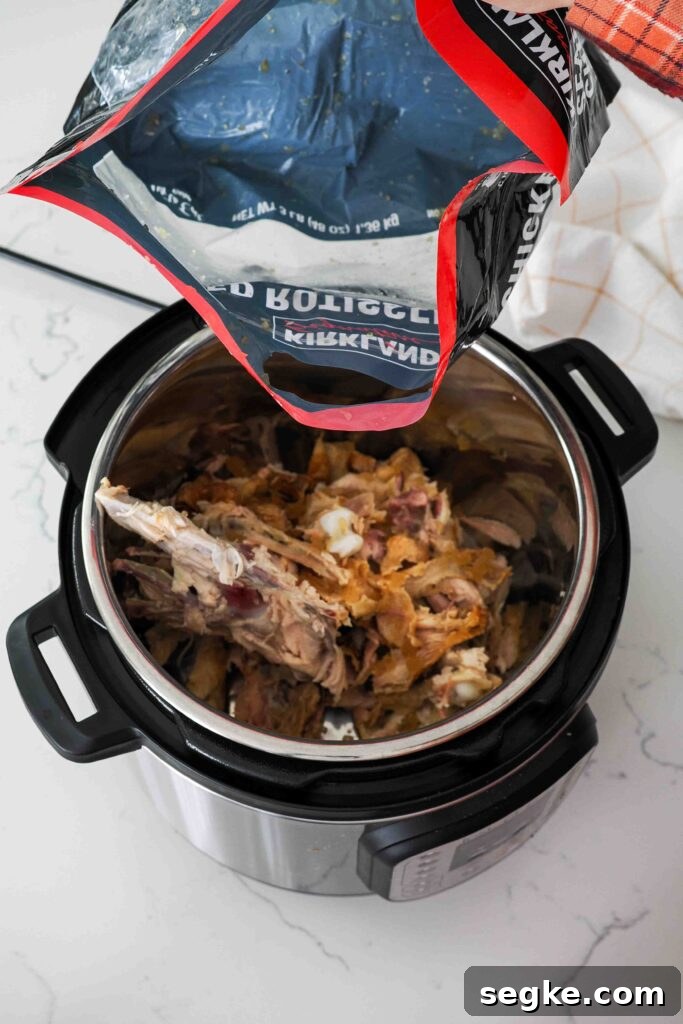 Instant Pot Chicken Bone Broth Recipe 4 Chicken bones, skin, and leftover meat from a rotisserie chicken bag in the pot of an Instant Pot.