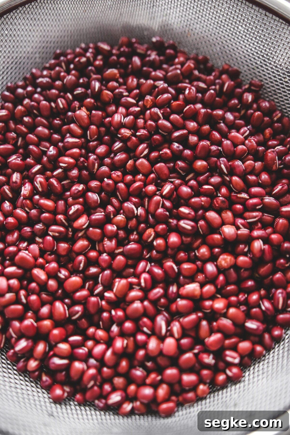Japanese Zenzai Recipe: Sweet Red Bean Soup 3 red beans in a metal sieve.