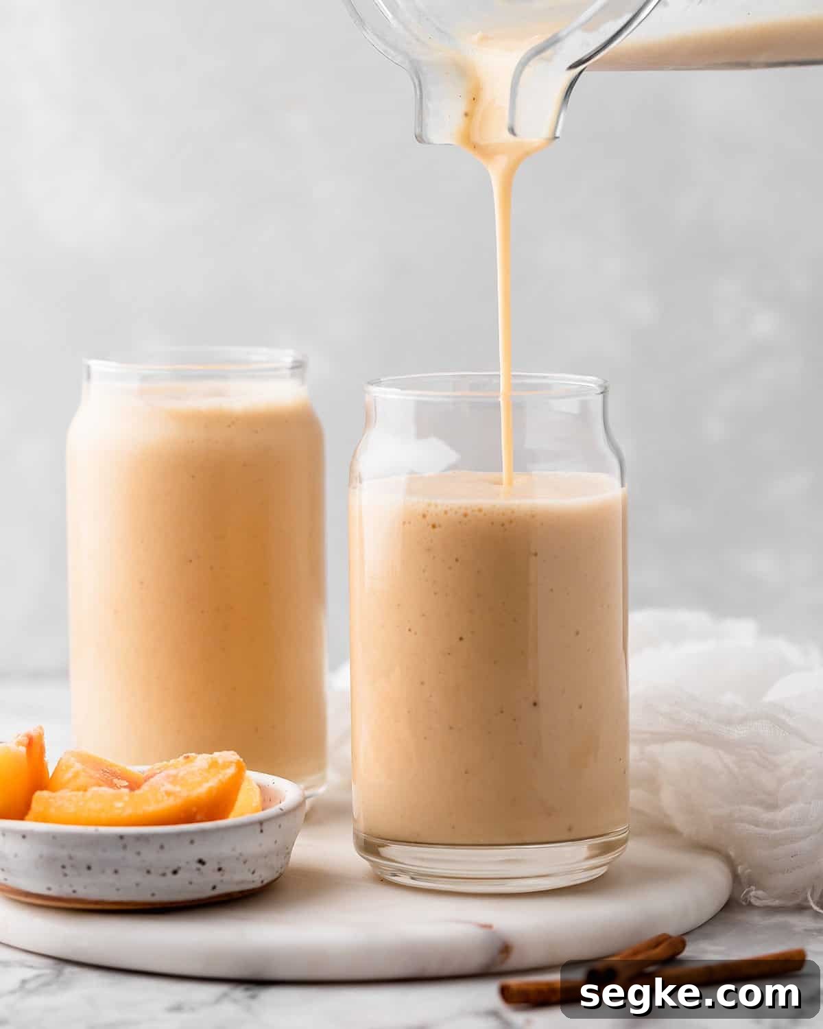 Banana Peach Smoothie being poured into a glass