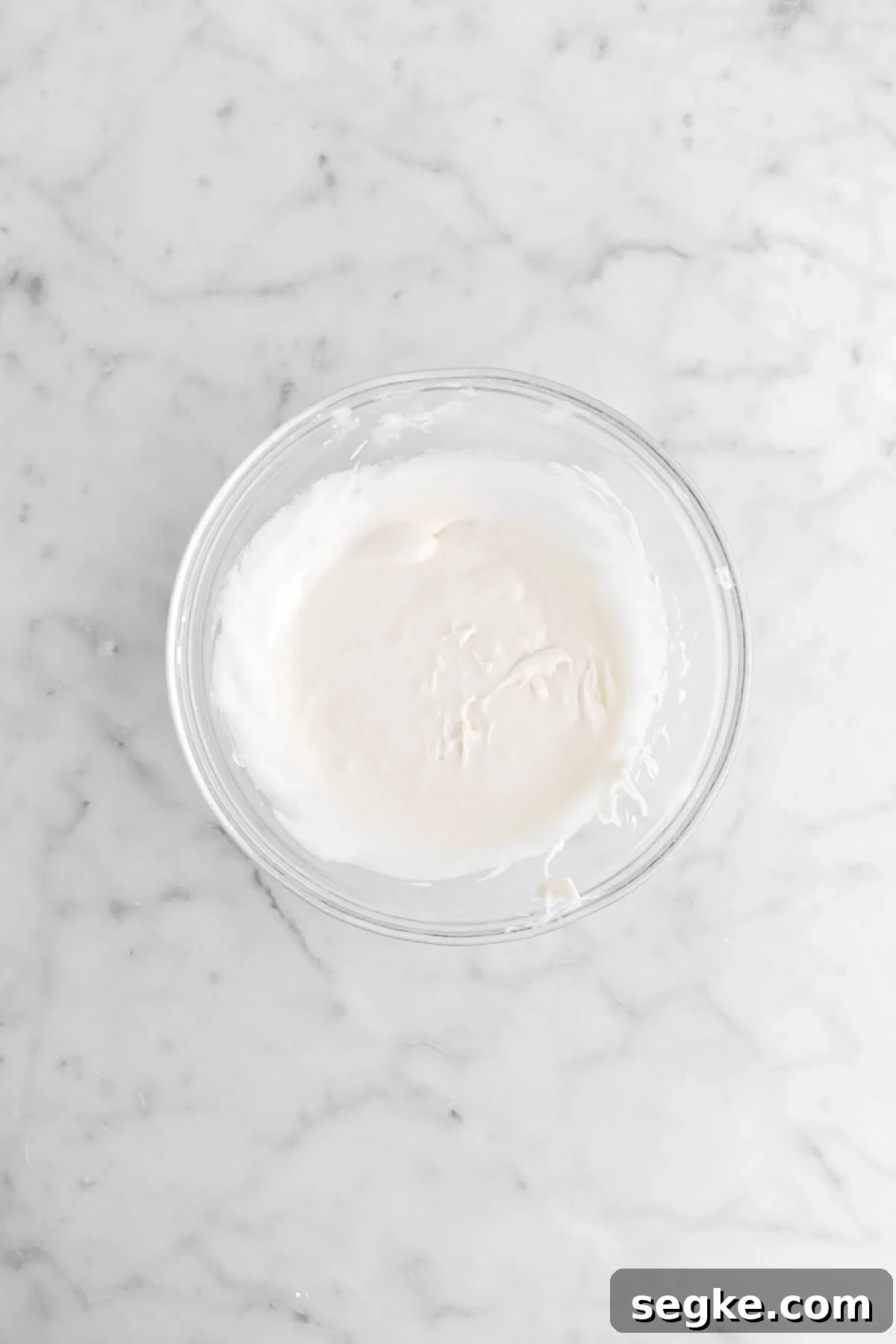 vanilla icing in glass bowl.